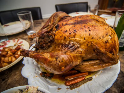 A large Thanksgiving turkey on a plate on a table.