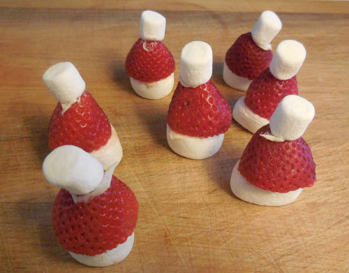 Santa hats made of strawberries and marshmallows.