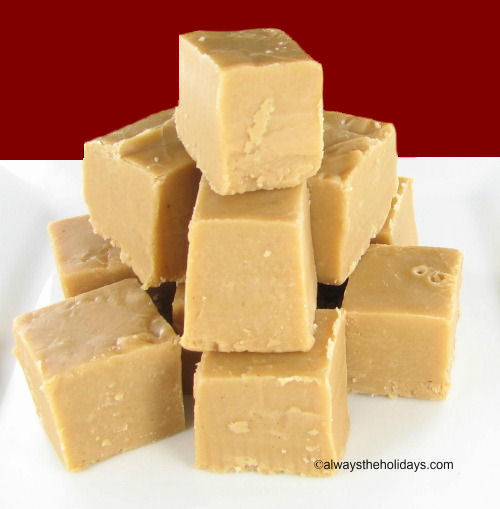 A pile of Bailey's Irish cream fudge on a white plate against a red background.