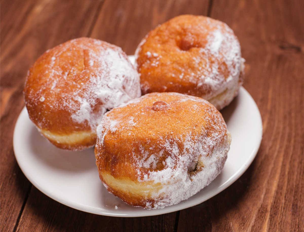 Food holidays in June: Jelly filled donuts on a white plate.