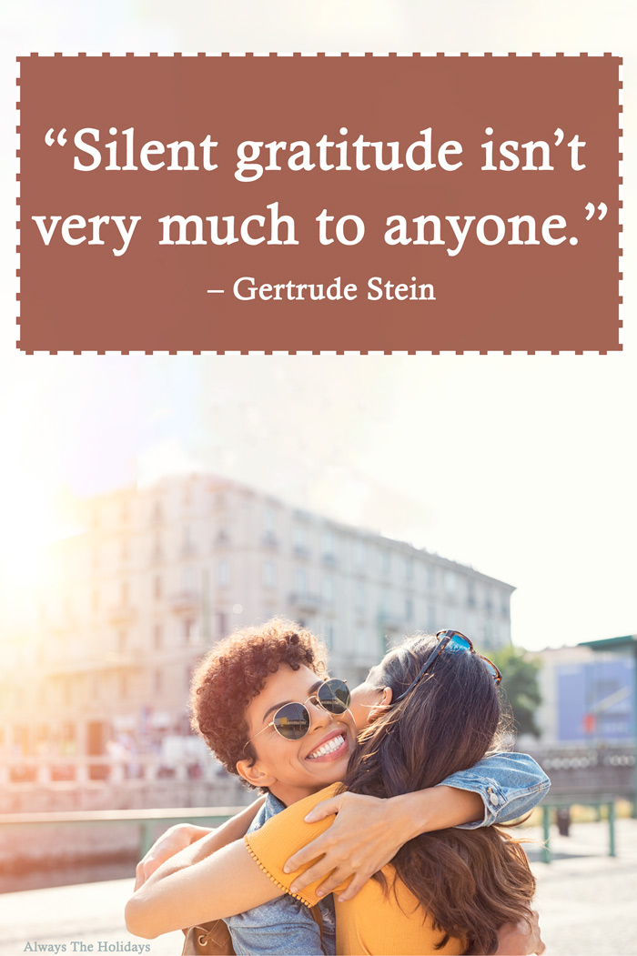 Two women hugging outside in front of a grey building with a thankful message for Thanksgiving text overlay reading “Silent gratitude isn’t very much to anyone.”.