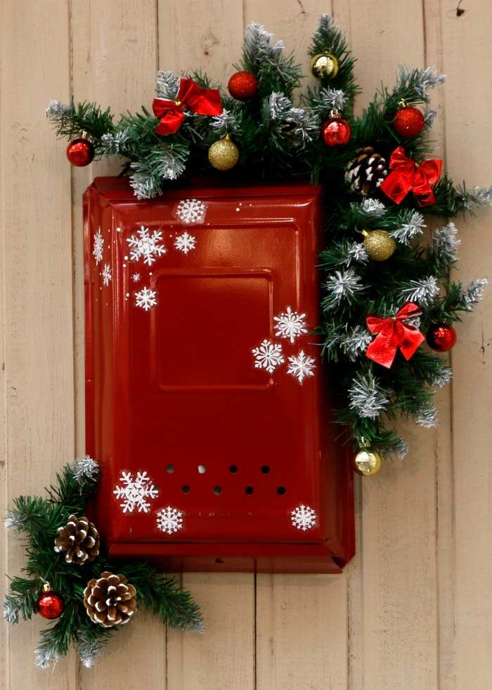 Red mailbox with garland and snowflakes