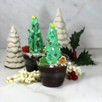 Christmas tree dirt cups with porcelain trees and Christmas decorations.