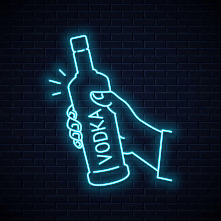 A neon sign of a hand holding a bottle with the word "vodka" written on it vertically.