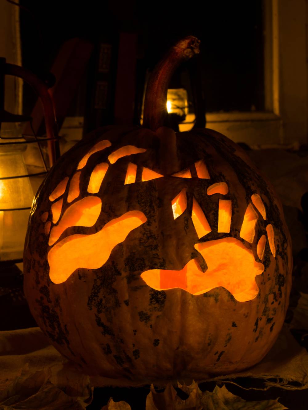 A skeleton pumpkin carving featuring skeleton hands.