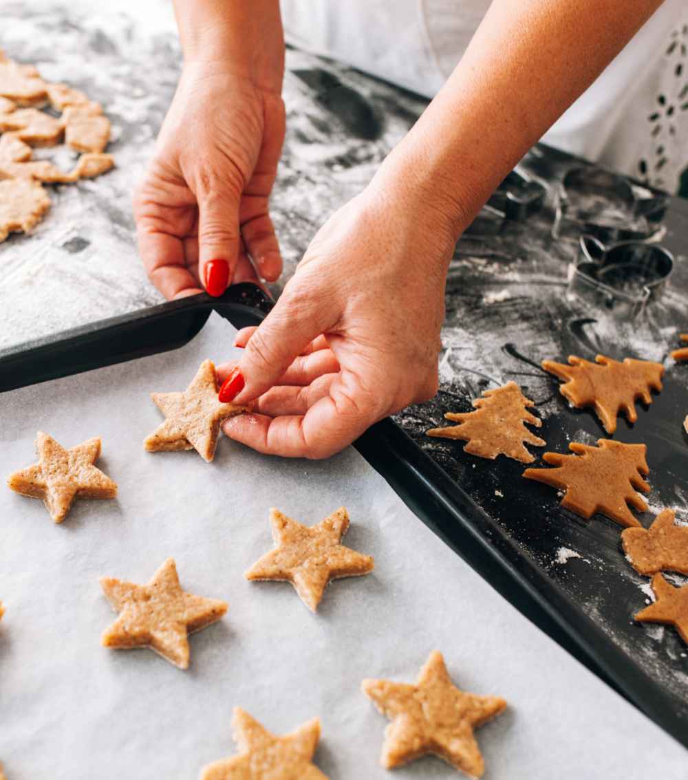 Woman making star shaped cookies.