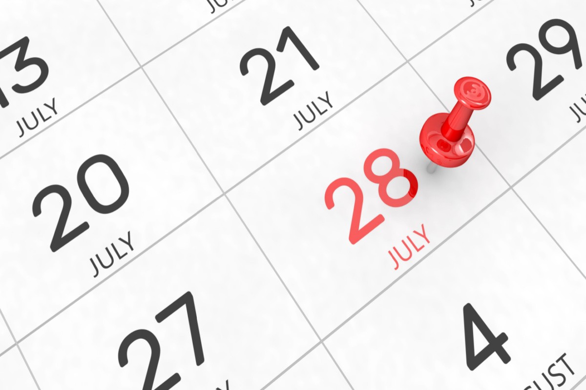 A calendar of July with the day 28 in red with a red push pin on it to highlight the significance of July 28 national days.