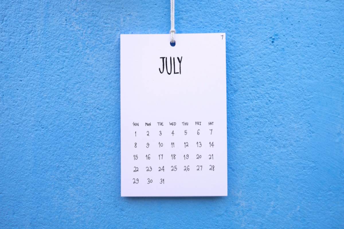 A July calendar against a plain blue background.