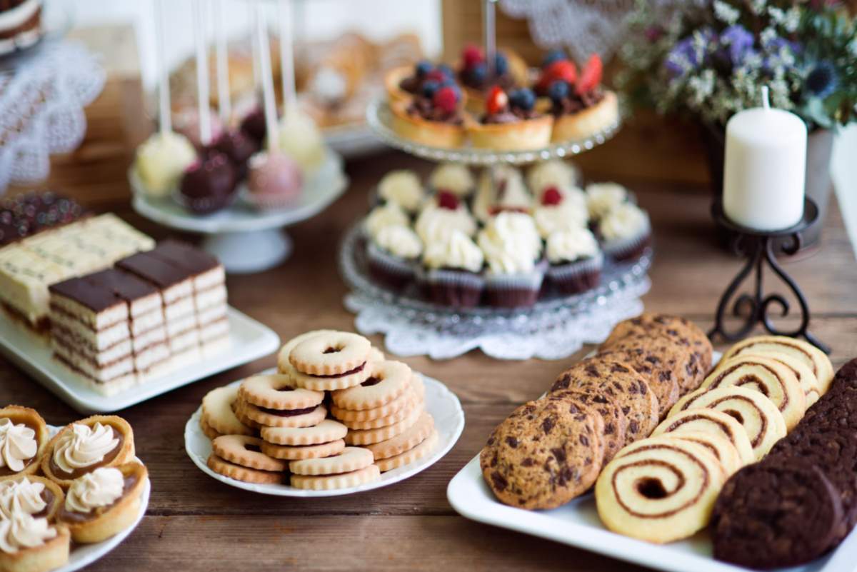 A full dessert table with assorted cookies, cupcakes, cake pops and more!