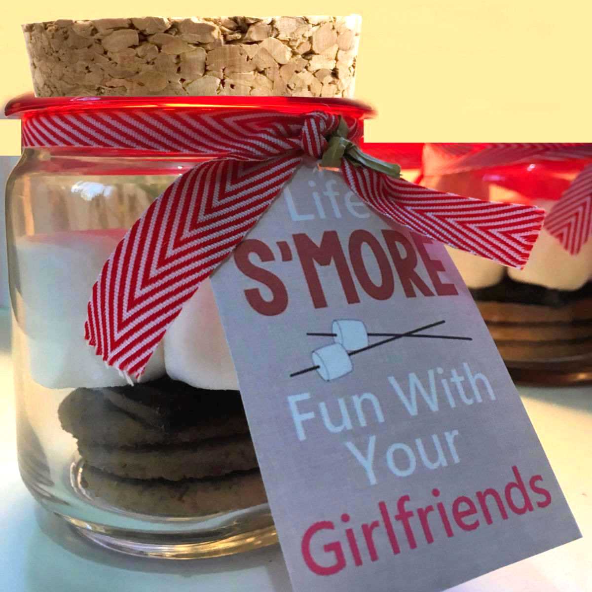 Jar with a cork and gift card, and s'mores ingredients.