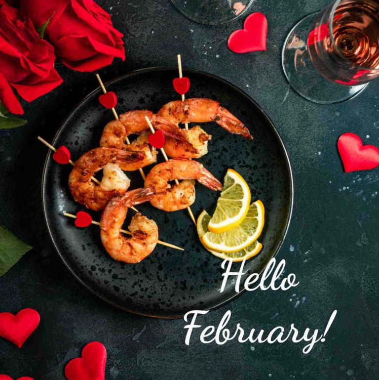 Shrimp on a plate with lemon and words Hello February.