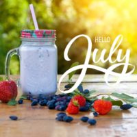 Blueberries, strawberries and a smoothie with words hello July.