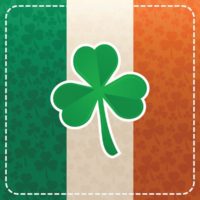A square that is made up of the colors of the Irish flag with faint shamrocks all over the image, a dotted border around the edges and a large shamrock in the center of the image.