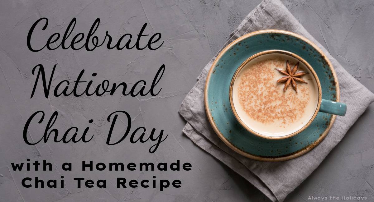 A grey background with a green teacup on a saucer placed on top of a grey napkin, filled with a homemade recipe for chai, garnished with star anise and a text overlay beside it that reads "Celebrate National Chai Day with a homemade chai tea recipe".