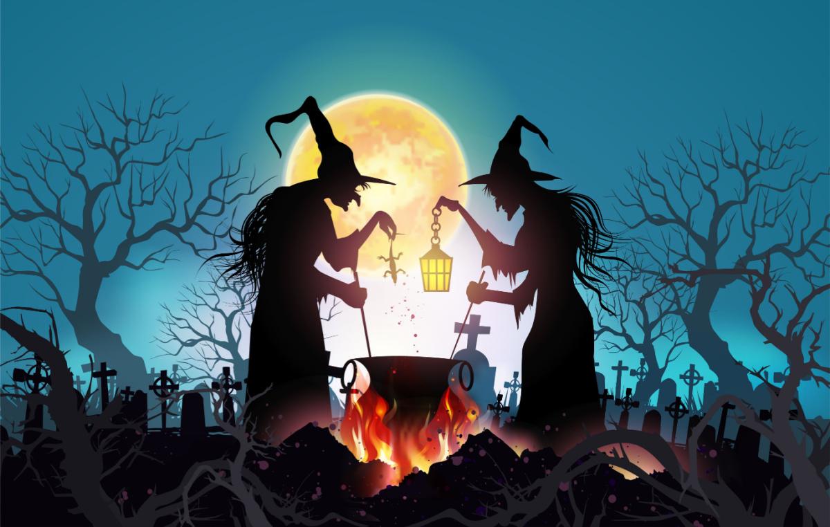 Two witches standing around a cauldron wearing pointed hats, one holding a lantern and one holding a lizard.