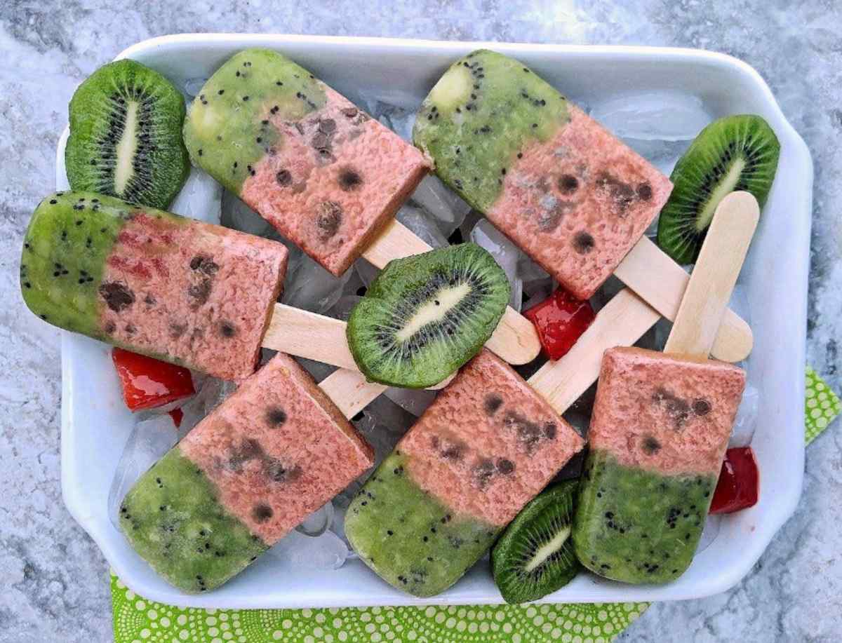 A white plate of six watermelon popsicles for summer.